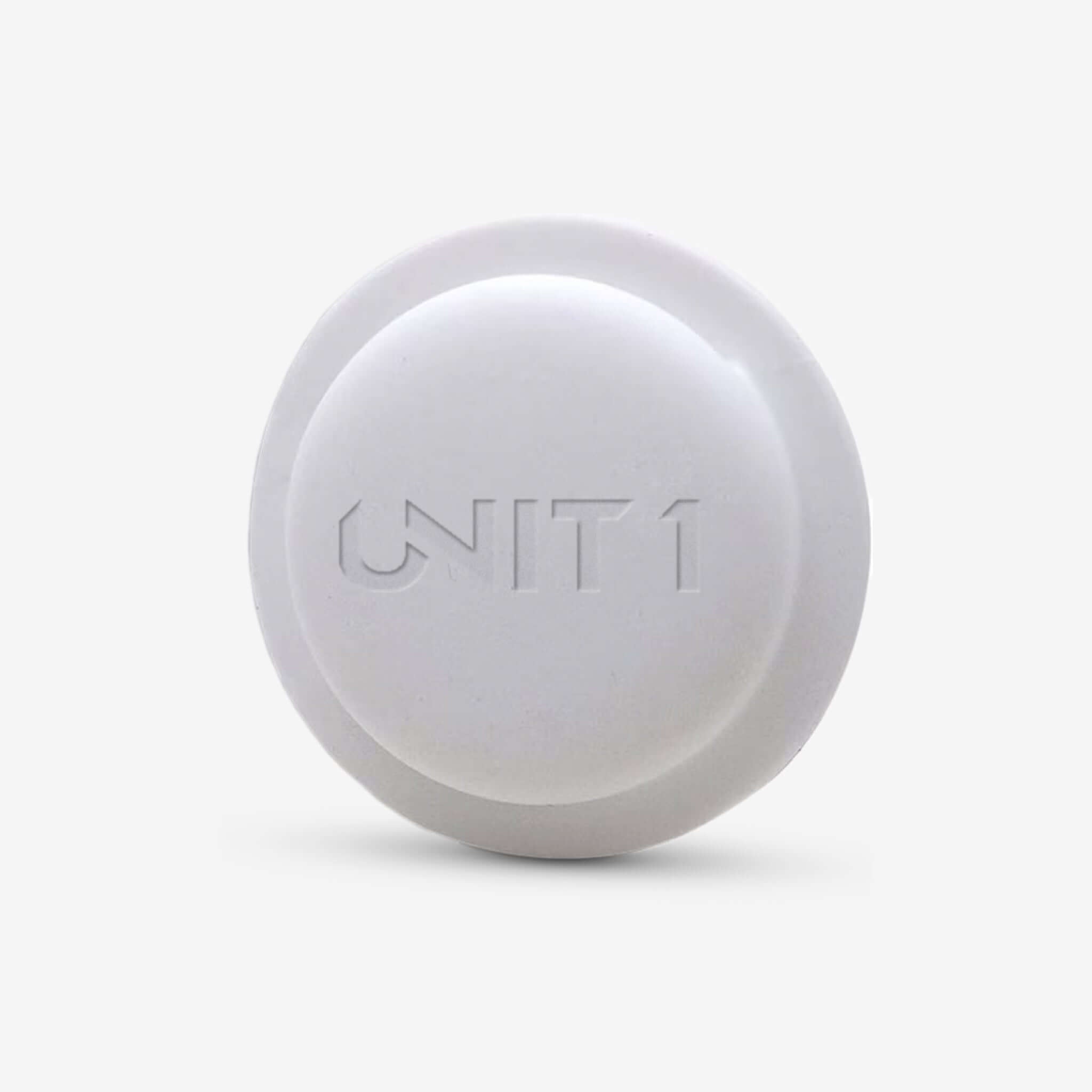 White round AirTag helmet holder with engraved UN1T 1 logo for secure attachment.